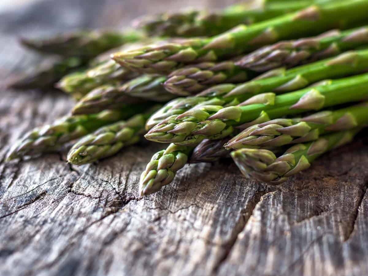 Fresh organic asparagus on rustic background.