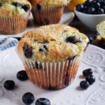 close up of a blueberry muffin on a white plate