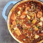 Beef stew in a light blue dutch oven.