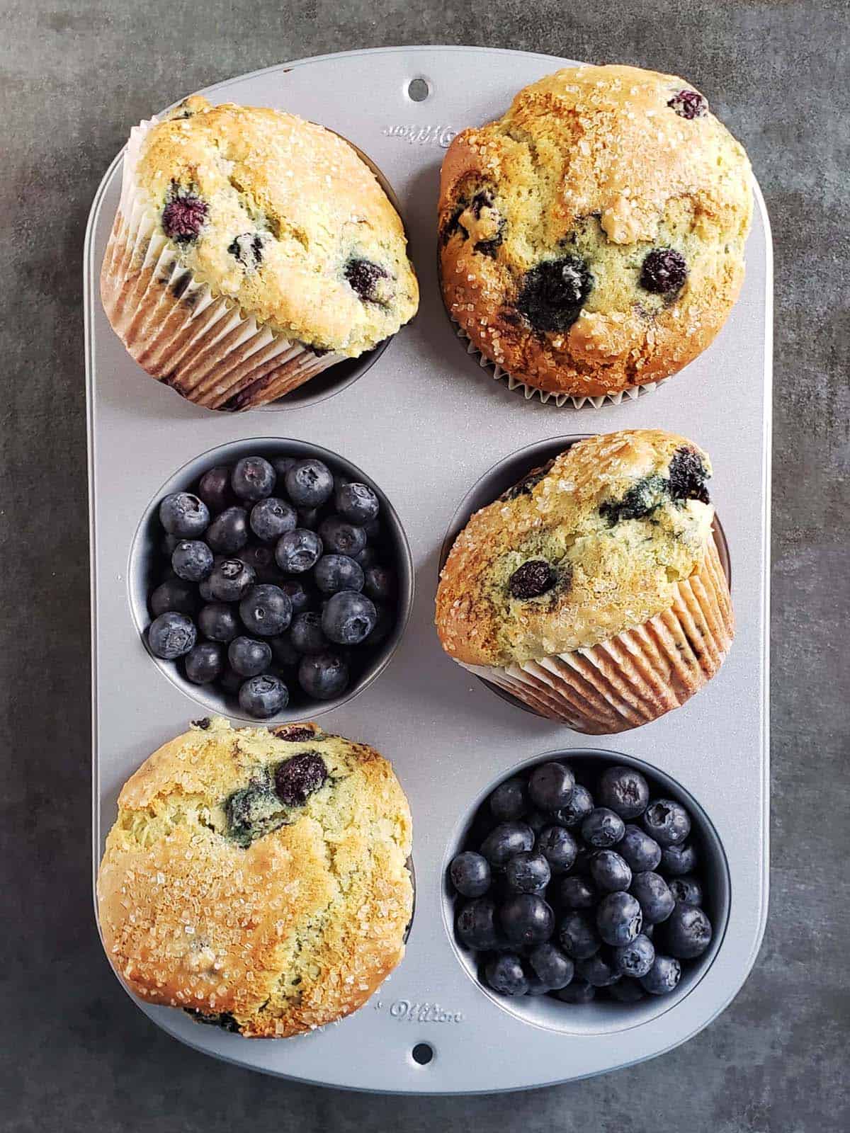 Blueberry muffins in a muffin pan.
