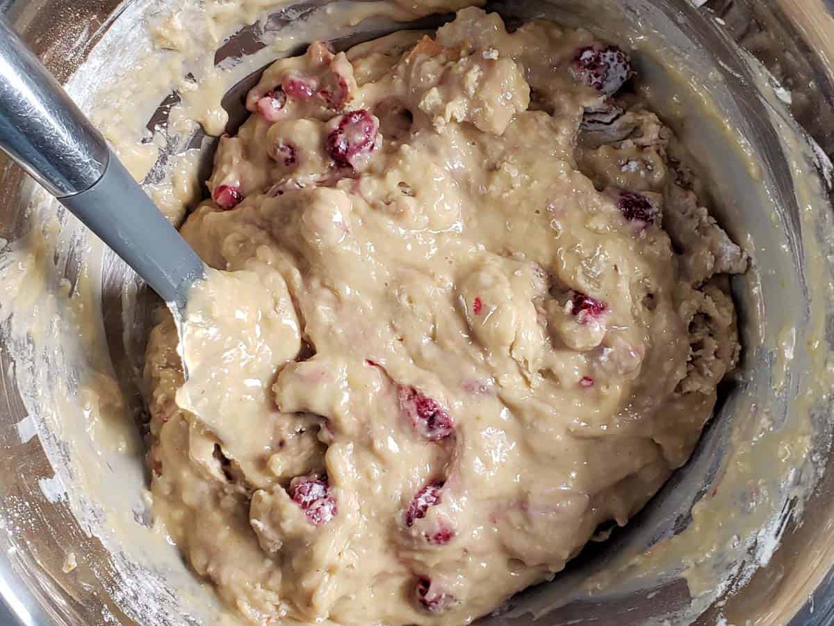 Raspberry apple muffin batter in a metal bowl.