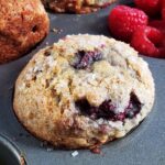 Close up of a raspberry apple muffin in a muffin tin.