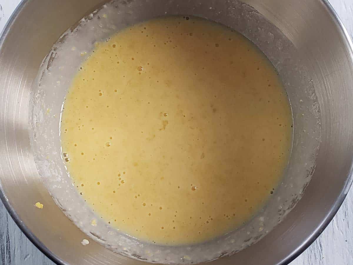 Mango pancake wet ingredients mixed together in a metal bowl.