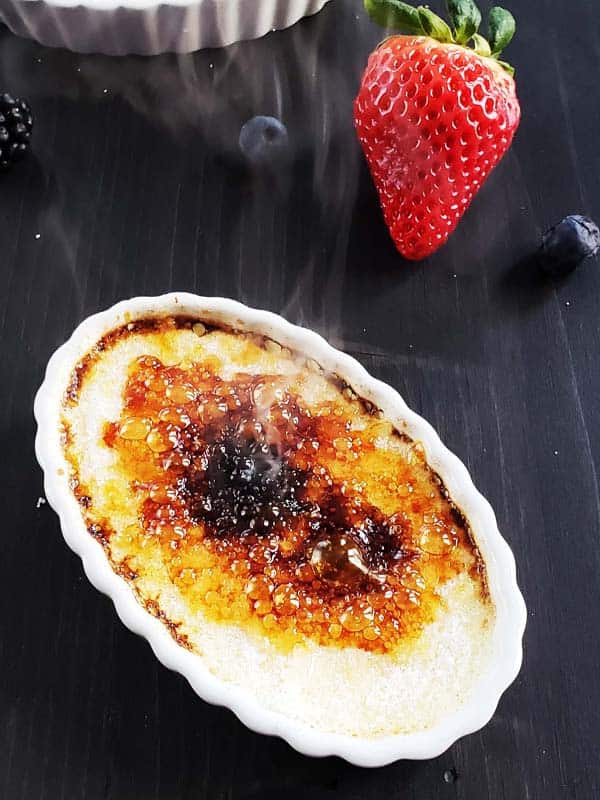 Smoke rising from recently bruleed creme brulee..