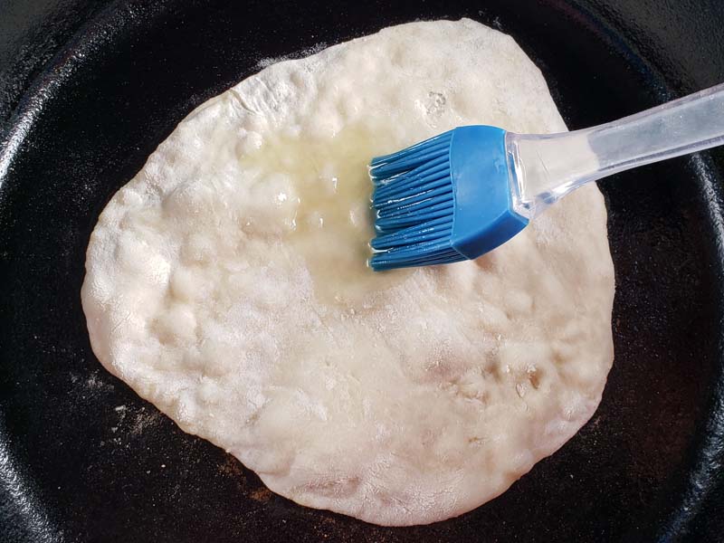 flatbread cooking in cast iron skillet