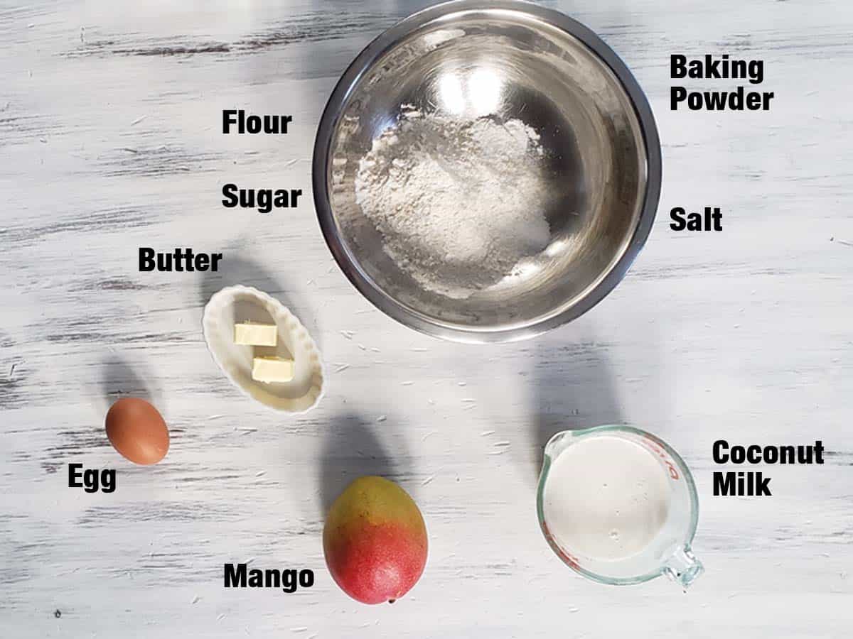 Mango pancake ingredients on a white surface.