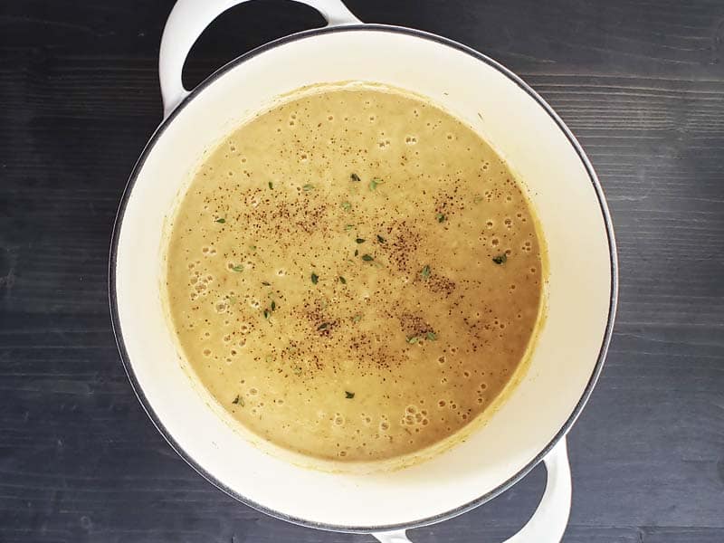 Roasted potato cauliflower leek soup pureed in a white dutch oven.
