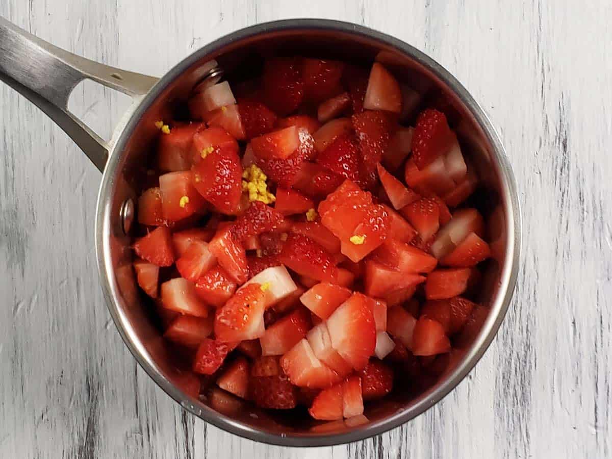 Chopped strawberries in a saucepan.