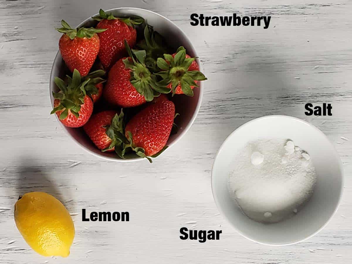 Strawberry lemon syrup ingredients on a white surface.