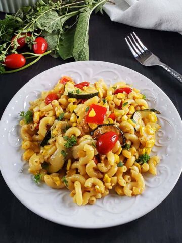 roasted vegetable pasta salad on a white plate