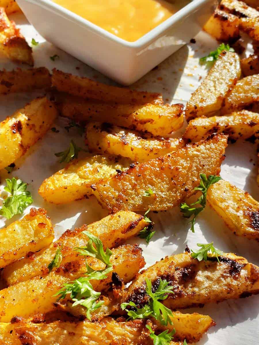 baked kohlrabi fries on parchment paper