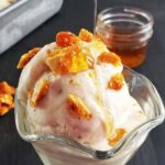 glass dish filled with ice cream and drizzled with honey