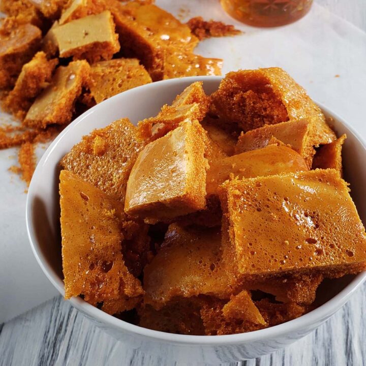 Honeycomb candy piled in a white bowl.