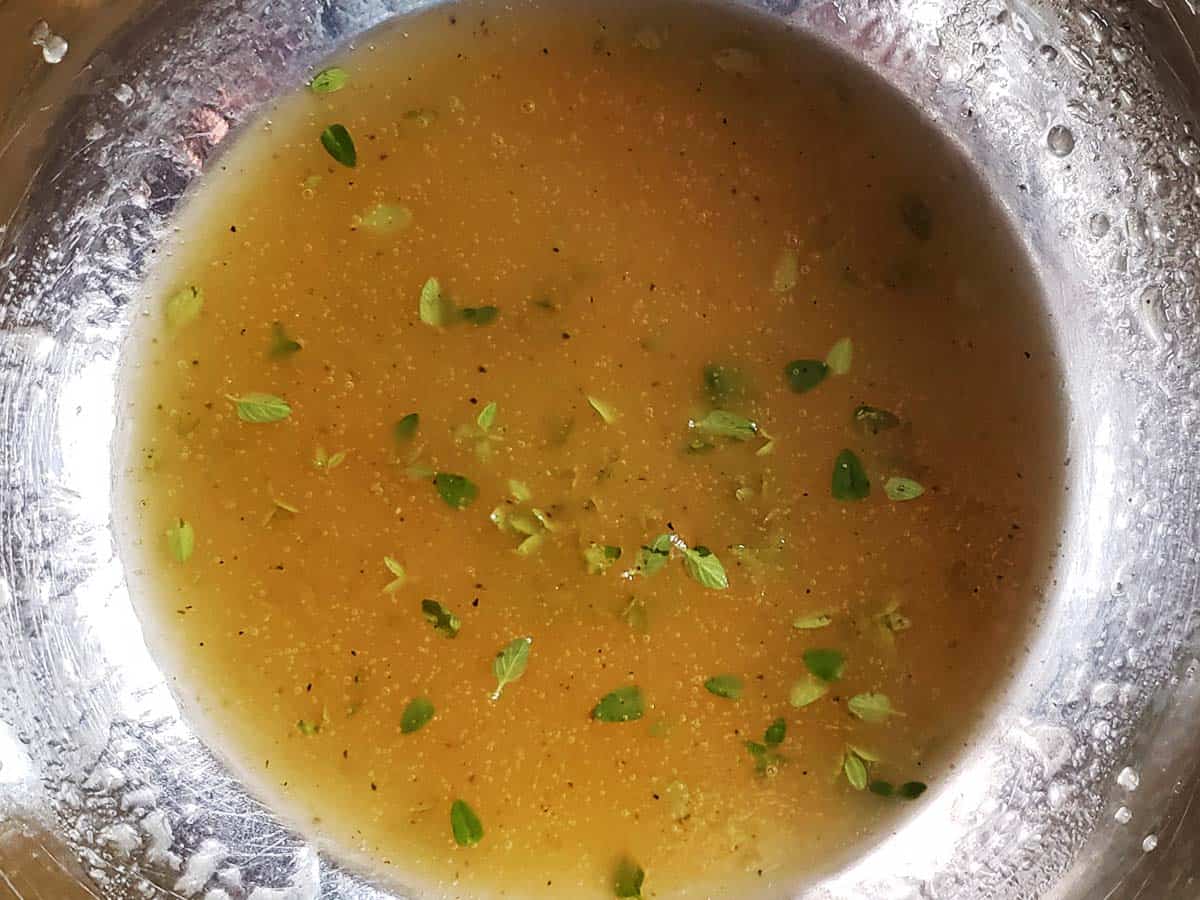 Apple cider honey dressing in metal bowl.