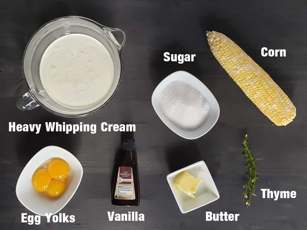 Sweet corn creme brulee ingredients on a dark background.
