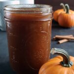 Pumpkin spice simple syrup in a glass jar.