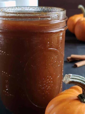 Pumpkin spice simple syrup in a glass jar.