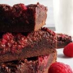 three raspberry nutella brownies stacked on top of each other