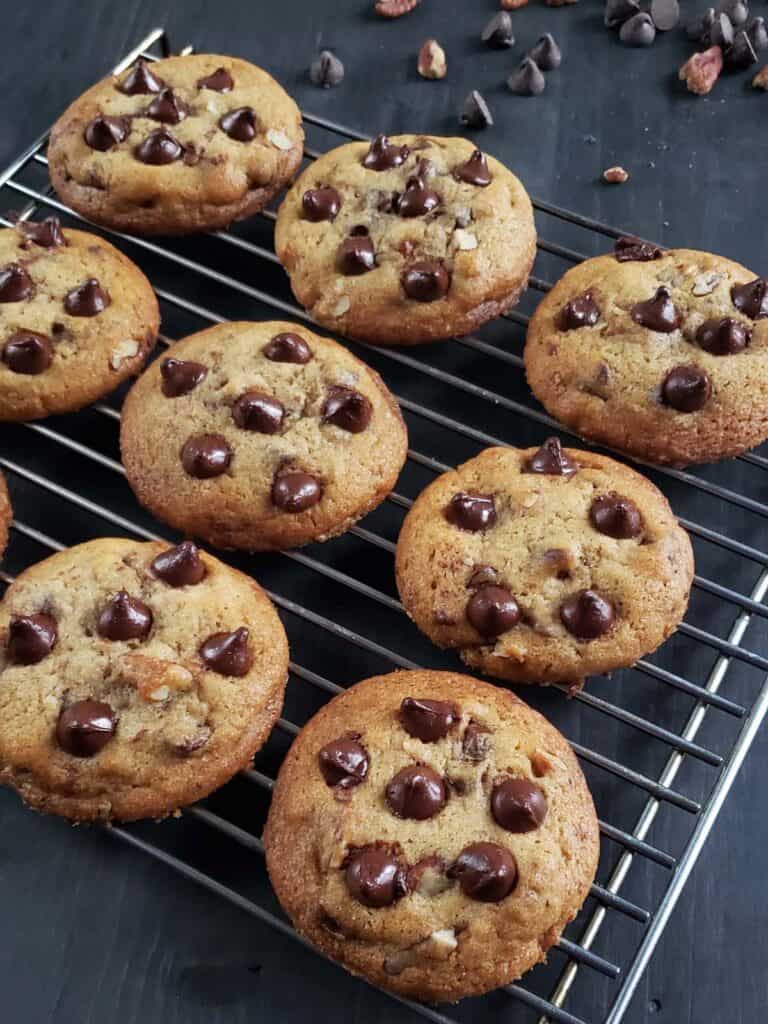 Chocolate chip cookies on a cooling rack.
