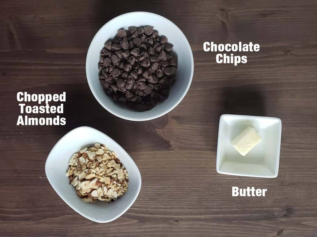 Chocolate icing ingredients on a wooden background.