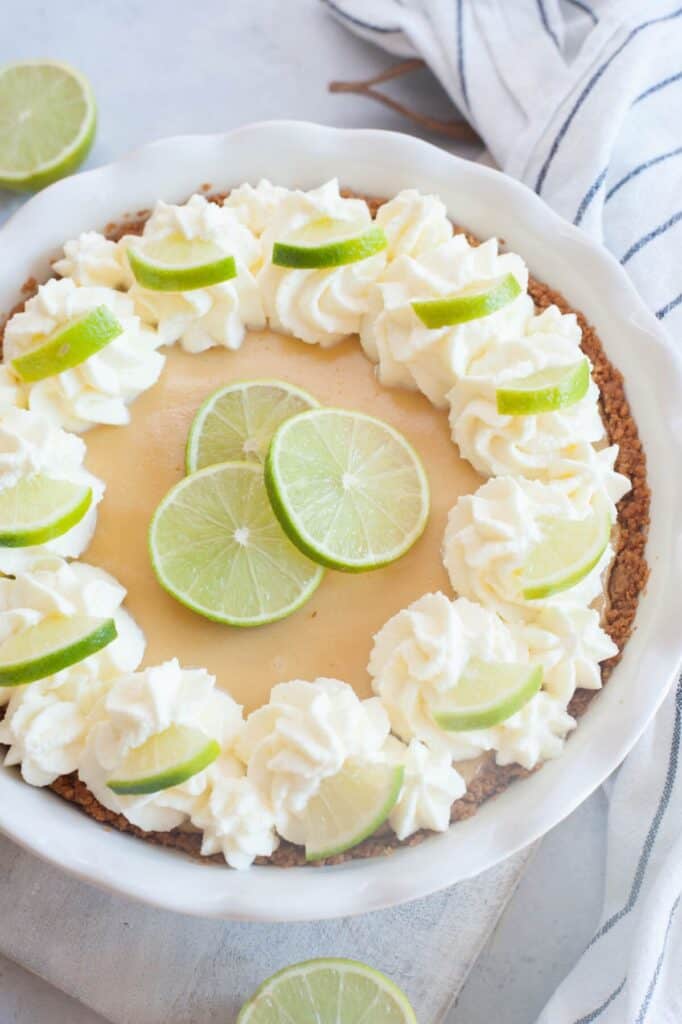 whole key lime pie on a white surface