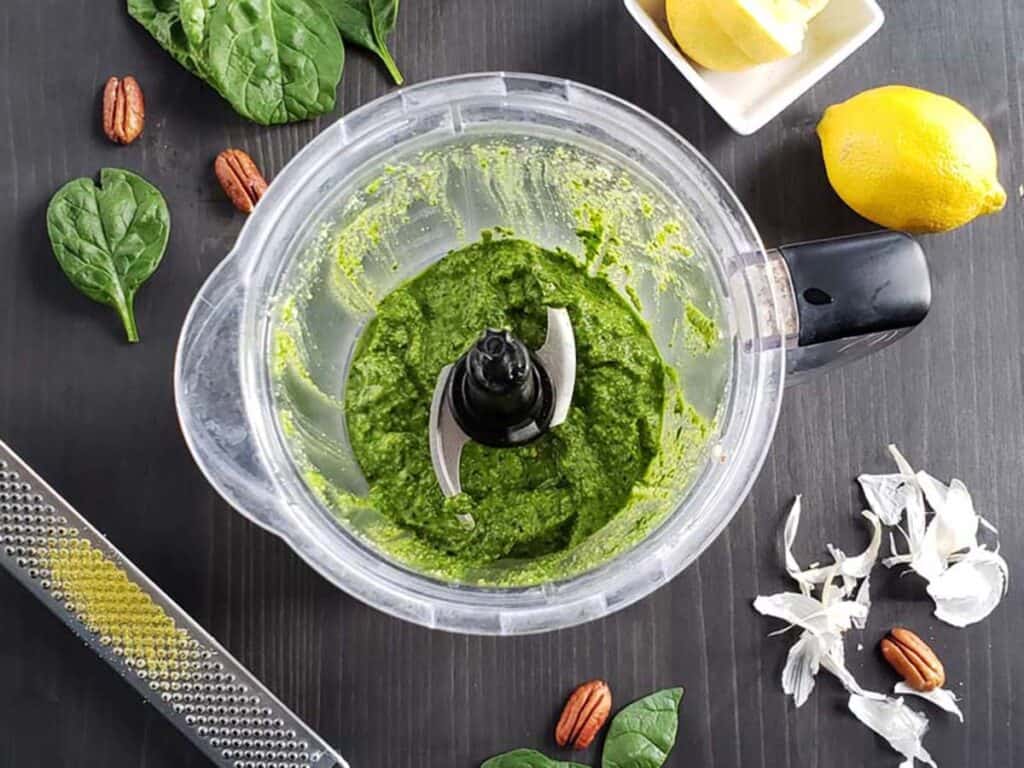 Pureed spinach pesto in a blender.