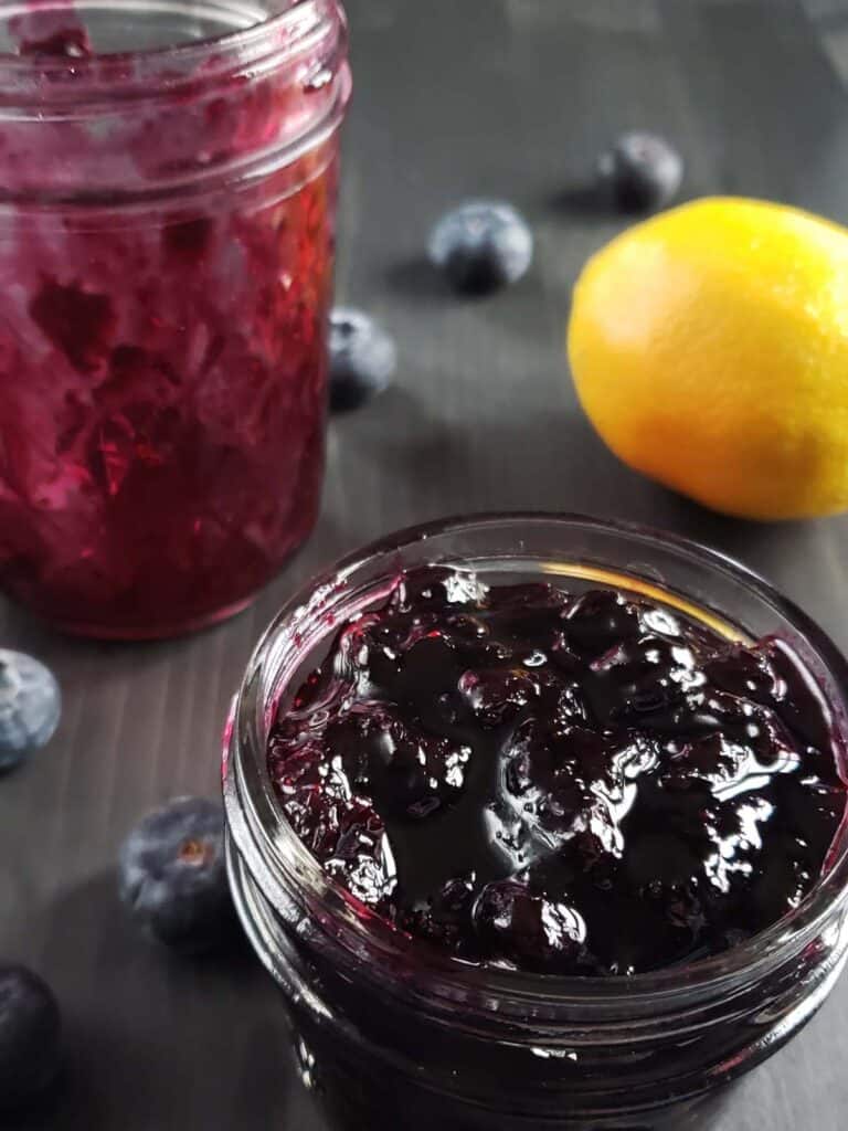 Small glass jar filled with blueberry jam.