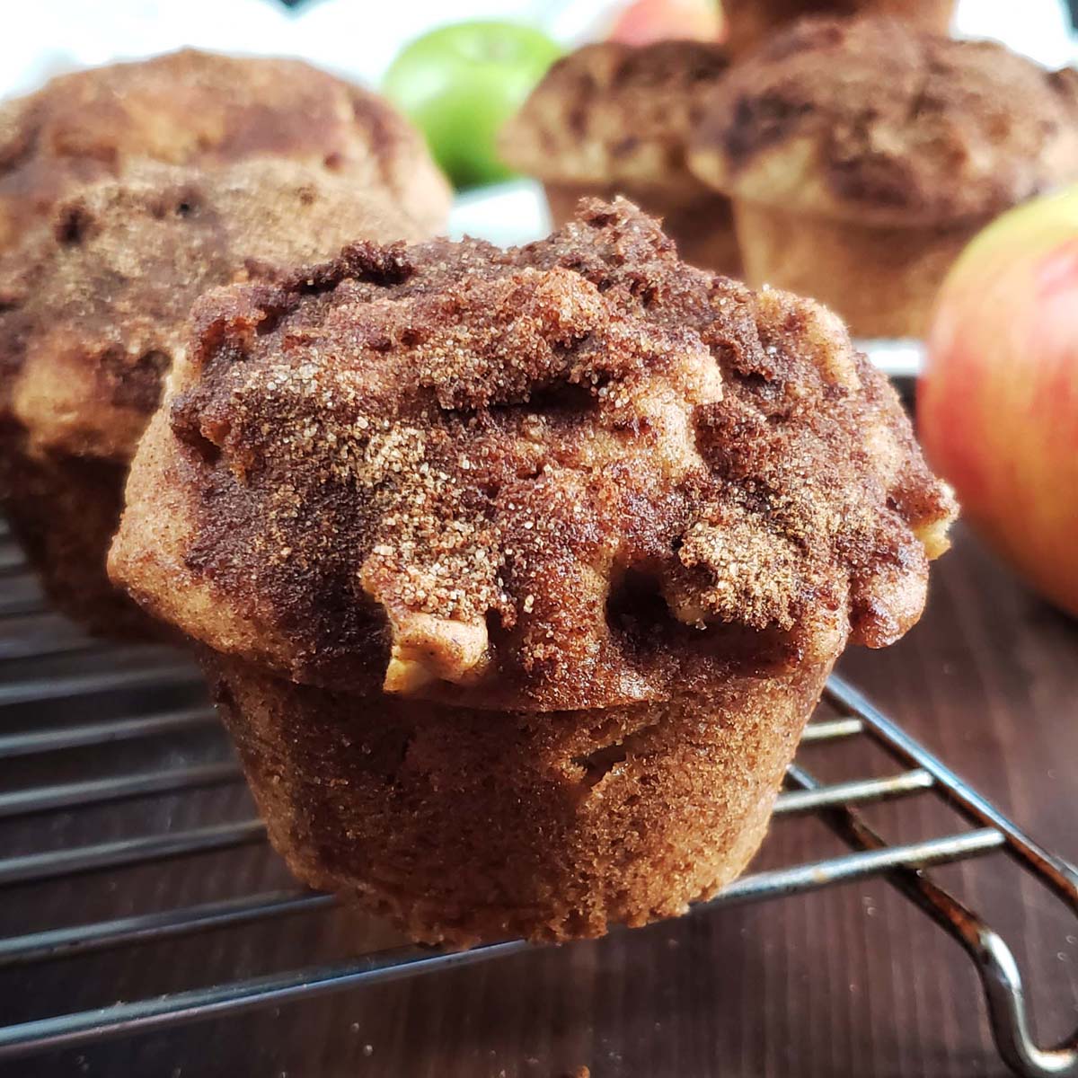 Sourdough apple cinnamon muffin on a cooling rack.