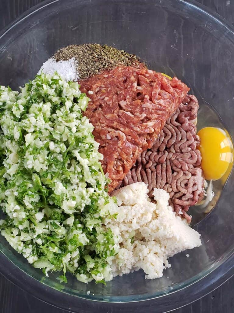 Meatball ingredients in a glass bowl.