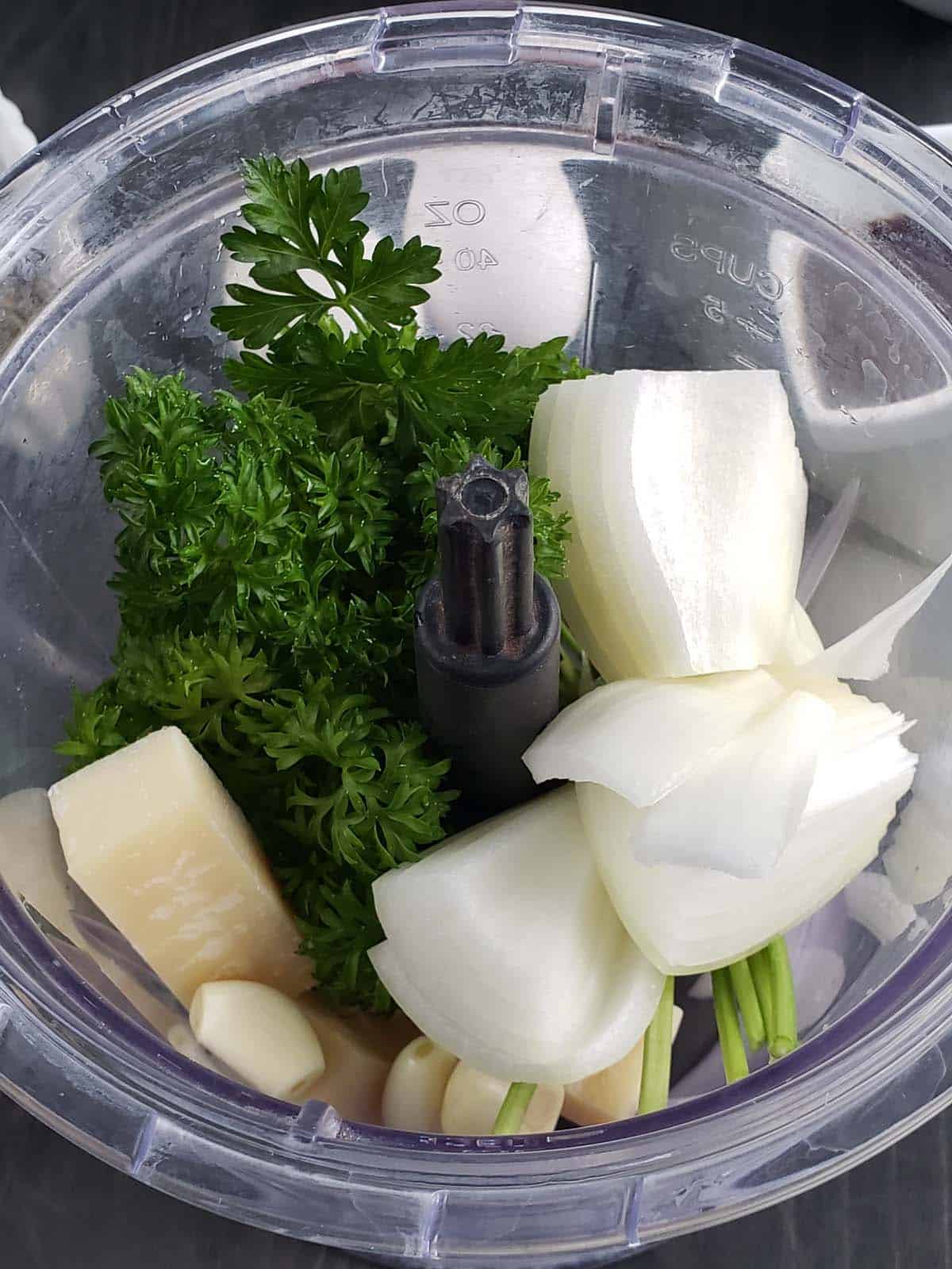 Parsley, onion, parmesan, and garlic in a blender.