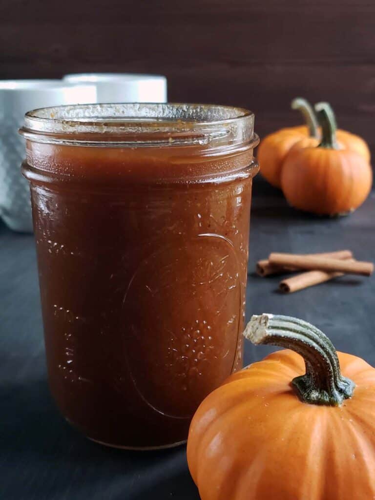 Pumpkin spice simple syrup in a glass jar.