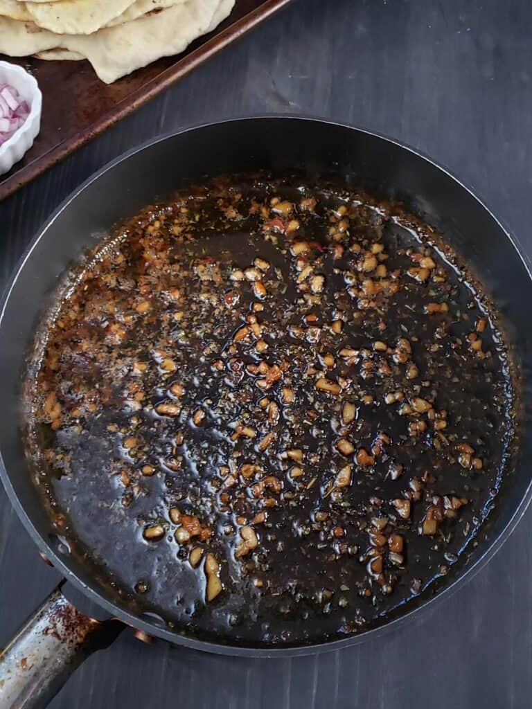 Shrimp scampi sauce in a sauce pan.