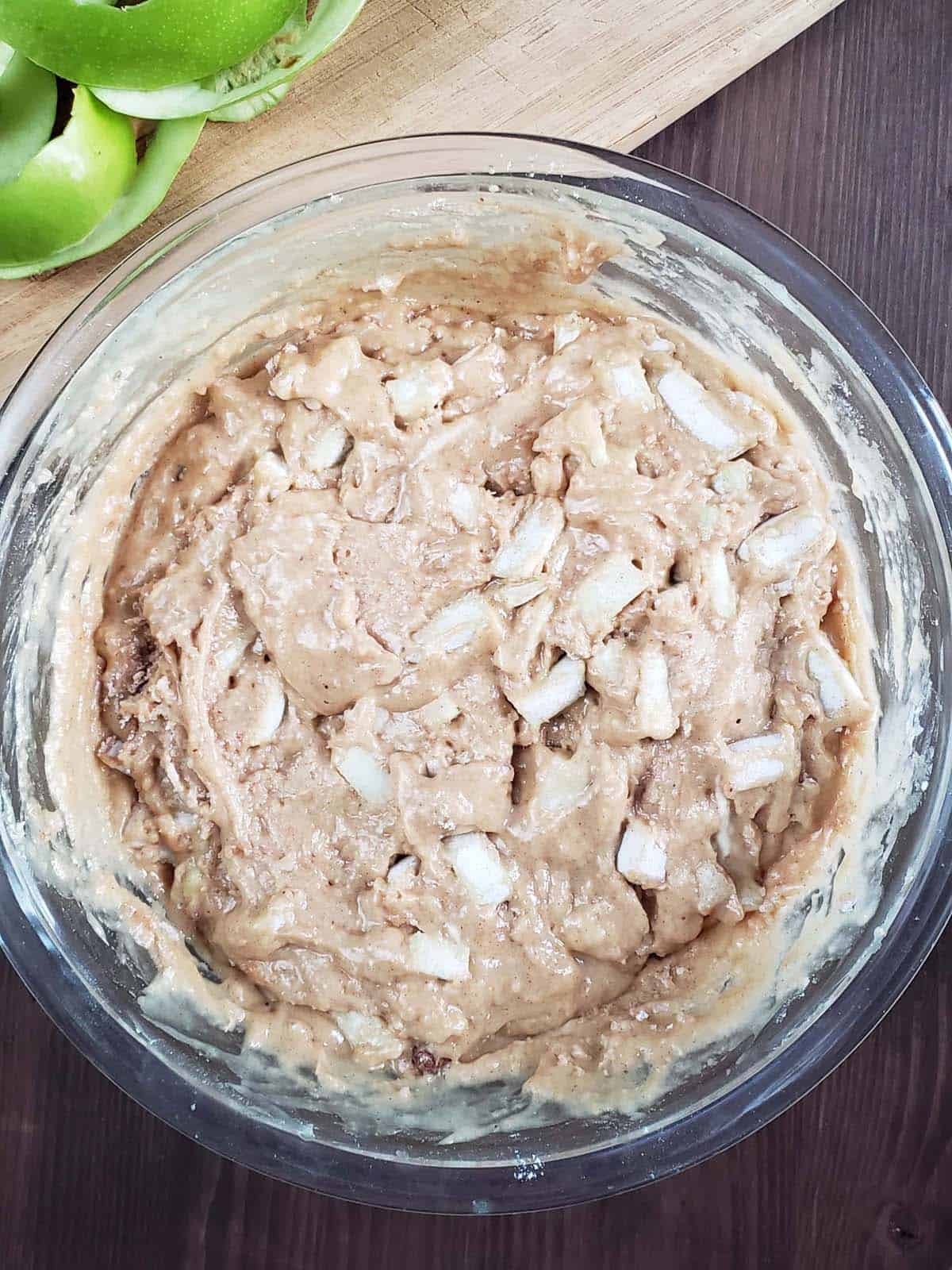 Sourdough apple cinnamon muffin batter in a glass bowl.