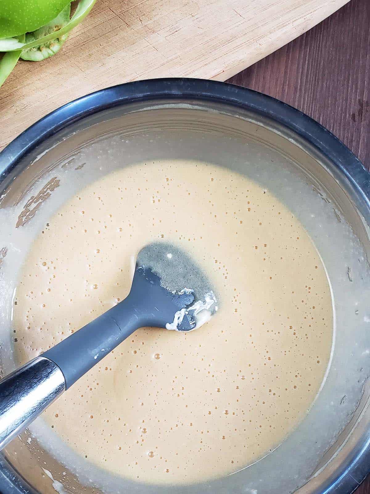 Wet ingredients mixed together in a metal bowl.