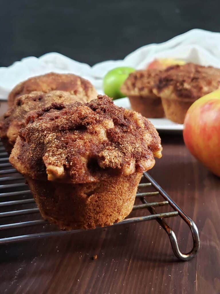 Sourdough apple cinnamon muffin on a wire cooling rack.
