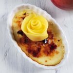 Mango creme brulee topped with a mango rose.