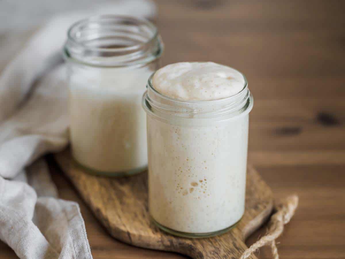 Two glass jars filled with sourdough starter.