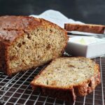 Sliced banana bread on a wire cooling rack.