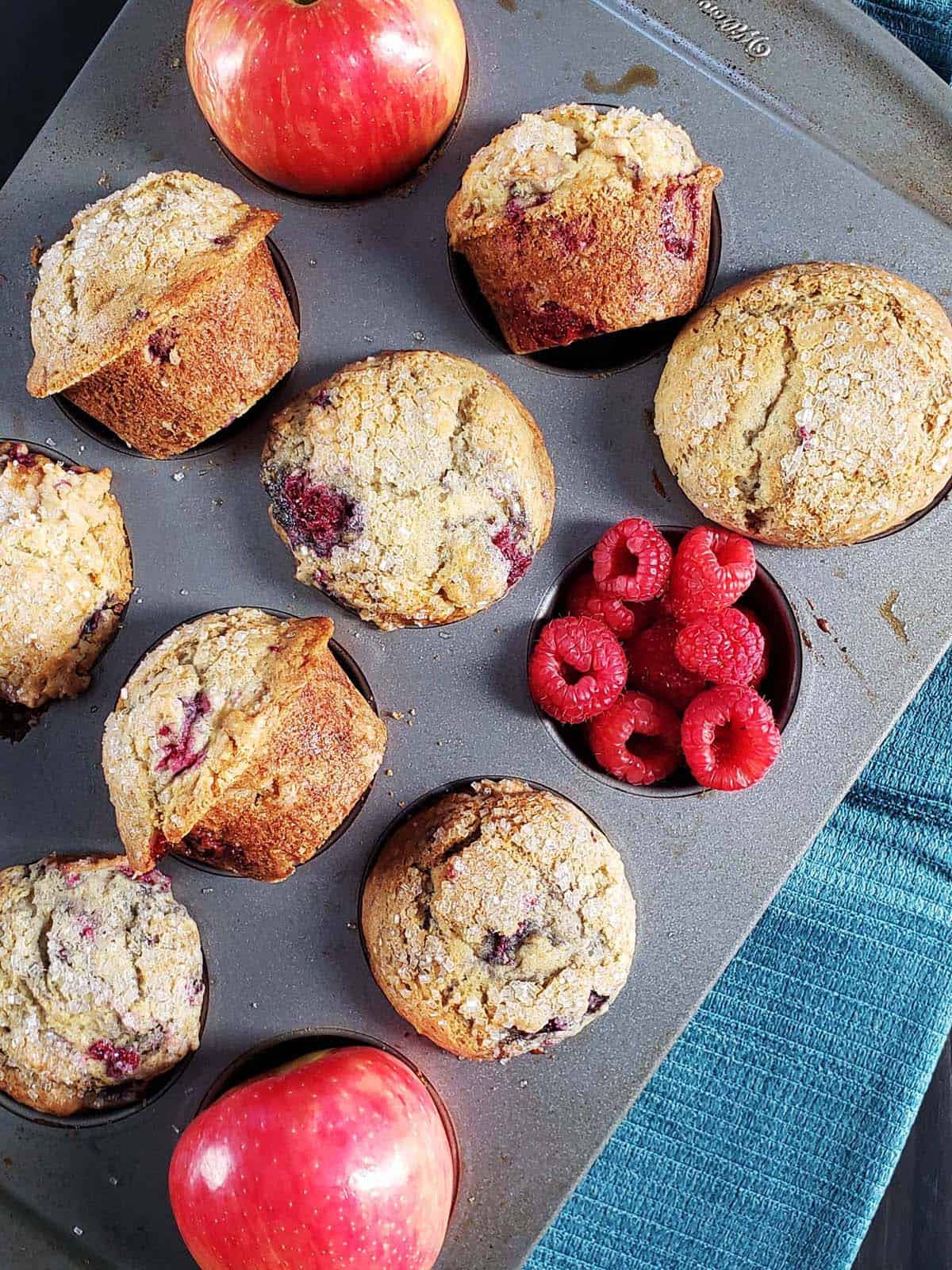 Apple raspberry muffins in a muffin tin.
