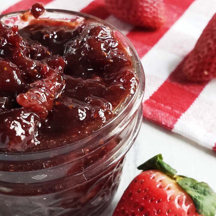 Roasted strawberry jam in a glass jar.