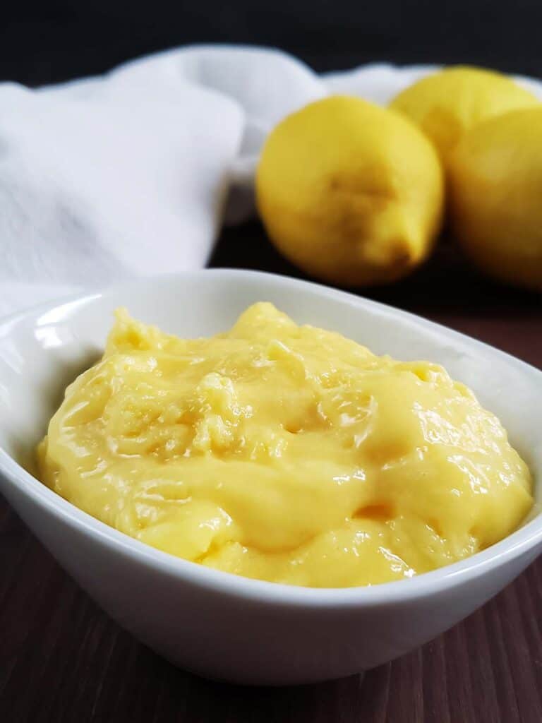 Lemon curd in a white ceramic dish.