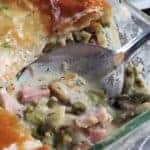 Ham and leek pot pie with a scoop missing.
