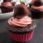 Chocolate strawberry cupcake topped with a chocolate covered strawberry.
