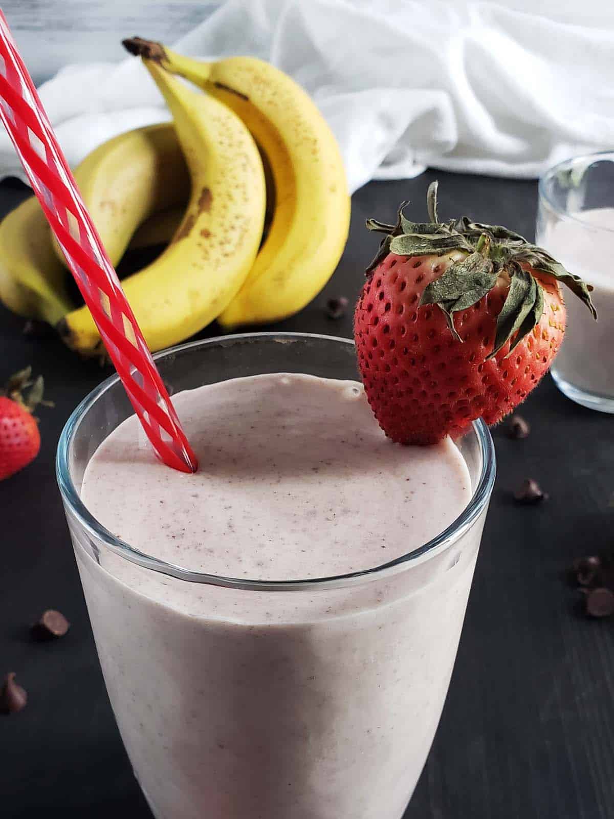 Strawberry banana chocolate chip smoothie in a glass.