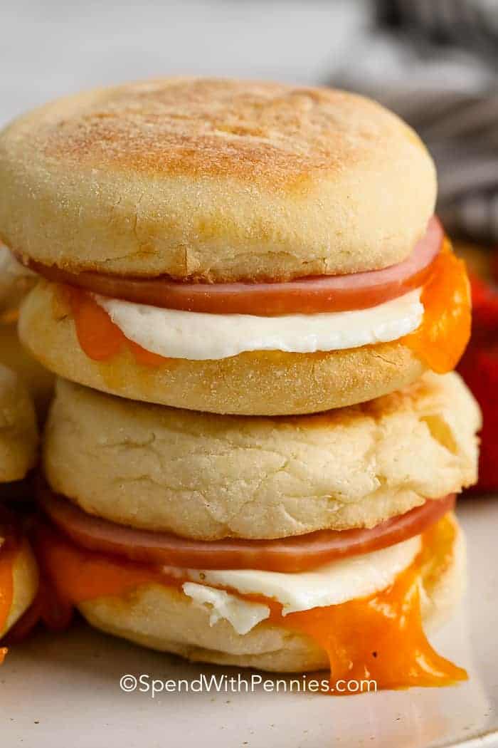 Stack of egg and ham breakfast sandwiches.