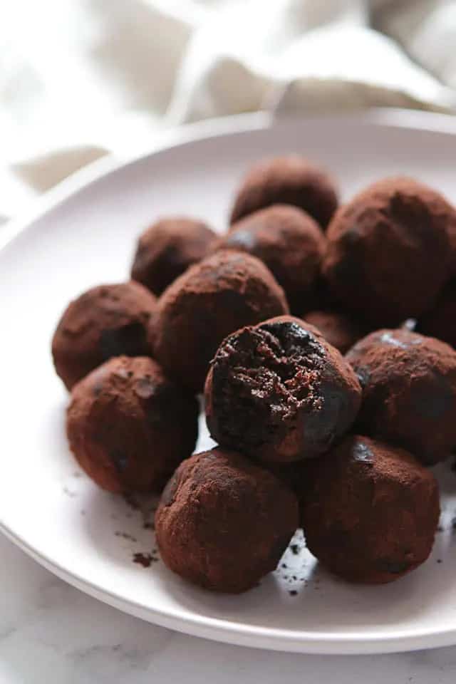 Chocolate energy balls on a white plate.