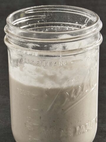 Glass jar filled with sourdough discard.