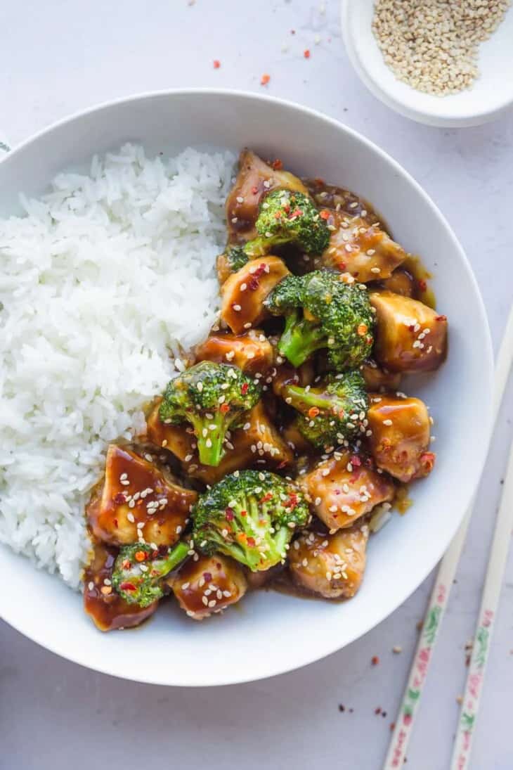 Chicken, broccoli, and rice on a white plate.
