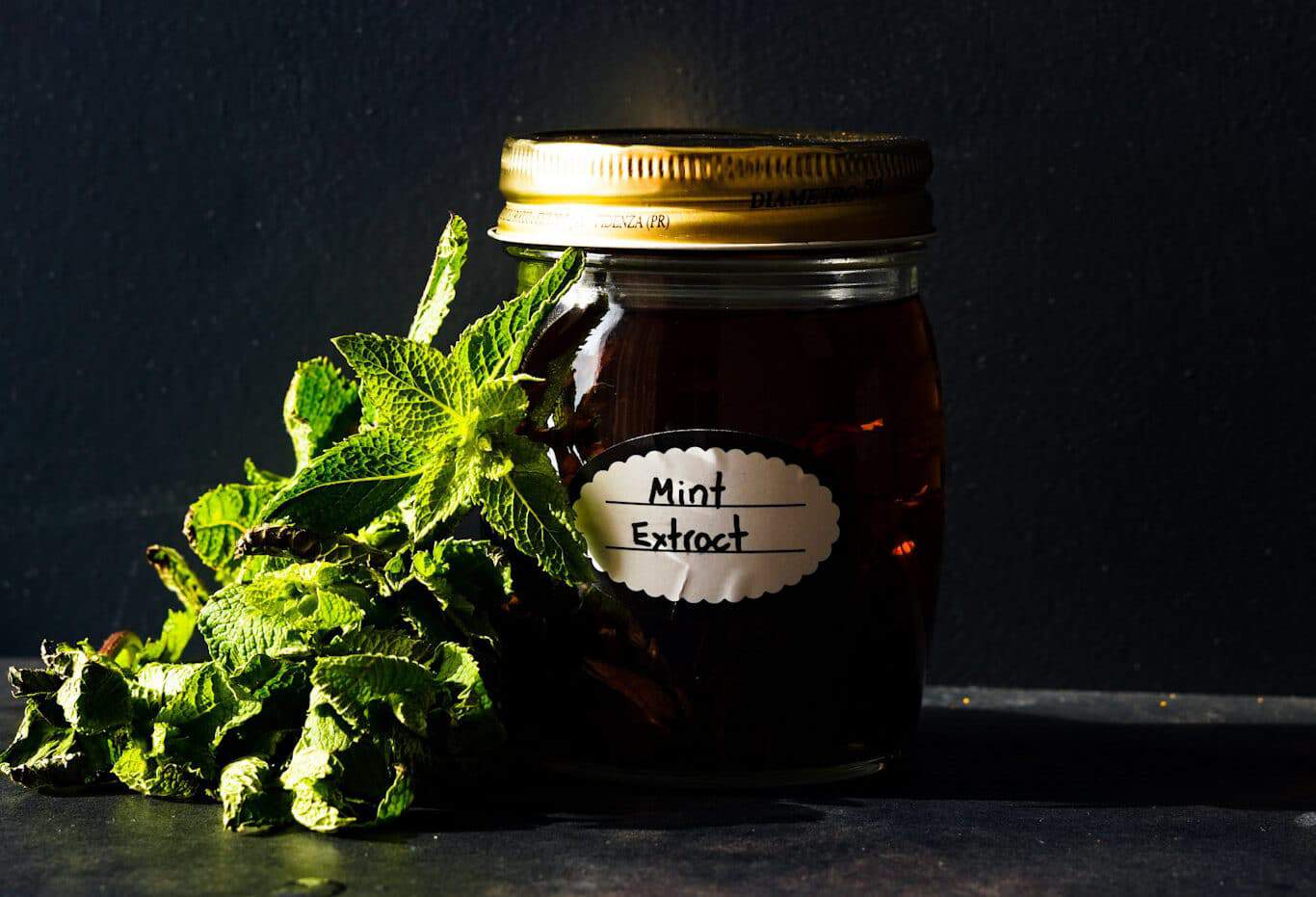 Mint extract in a glass jar.
