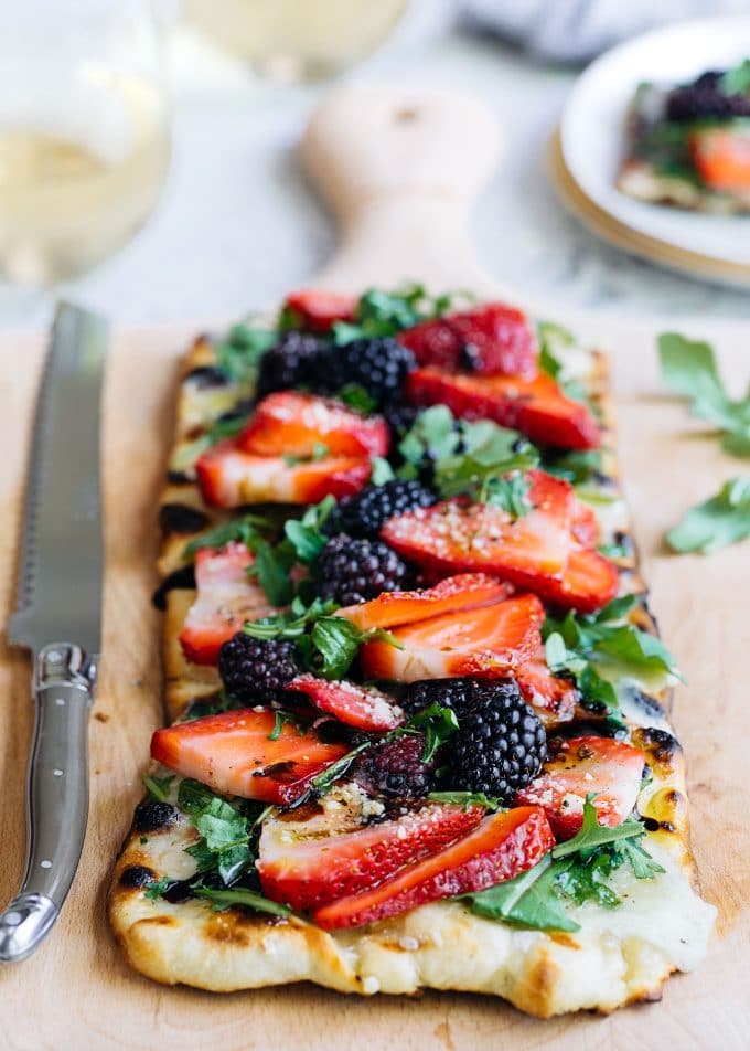 Flatbread pizza topped with mixed berries.